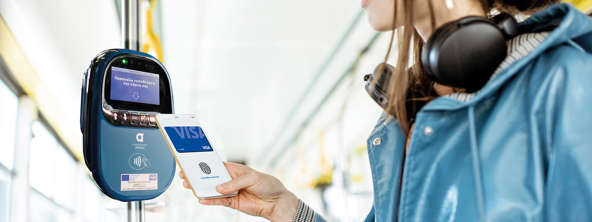 woman using mobile to pay for tram fair